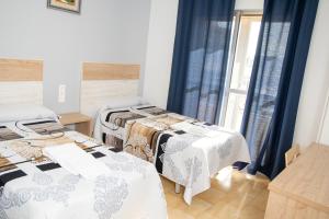 Postel nebo postele na pokoji v ubytování Pension Cuatro Vientos