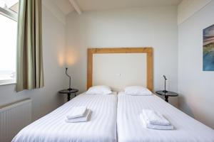 Giường trong phòng chung tại De Buteriggel