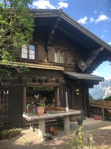 a wooden house with a table in front of it at Chalet Mex 15 in Saint-Maurice