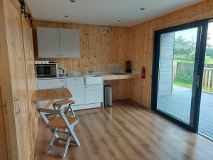 a kitchen with a table and chairs in a room at Callander Hostel in Callander