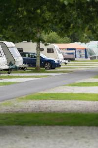 a group of camper vans parked in a parking lot at Safari Tent in Pentewan