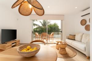 a living room with a bowl of fruit on a table at Mangata Gran Canaria - Adults Only in San Agustin