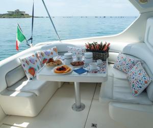 a tray of food on a table on a boat at Duca70 "Suite Home" in Taranto