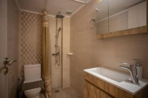a bathroom with a sink and a toilet and a shower at Galini Studio, next to the beach in Rethymno Town