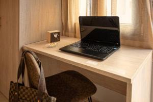 un ordinateur portable assis sur un bureau avec une chaise dans l'établissement Galini Studio, next to the beach, à Réthymnon