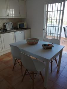 une cuisine avec une table bleue, des chaises et un comptoir dans l'établissement Apartamento Vista Mar, à Cabanas de Tavira