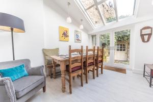 a dining room with a table and chairs at Tastefully decorated, family friendly property, central Kirkby Lonsdale, parking and EV charger in Kirkby Lonsdale