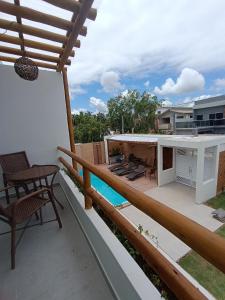a balcony with a view of a house at Flats Marina Maragogi in Maragogi