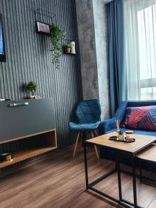 a living room with a blue couch and a table at Luxury Apartment/Studio in Plovdiv
