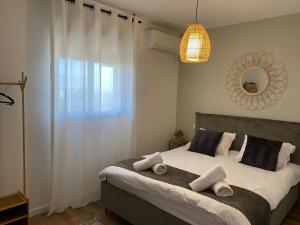 a bedroom with a large bed with towels on it at YANZ APARTMENT in Eilat