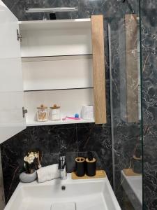 a bathroom with a sink and a mirror at Luxury Apartment/Studio in Plovdiv
