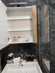 a bathroom with a sink and a mirror at Luxury Apartment/Studio in Plovdiv +24 photos