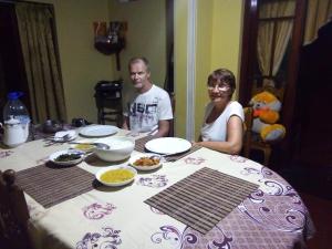 a man and woman sitting at a table with food at Freedom River House Villa in Ahangama +49 photos