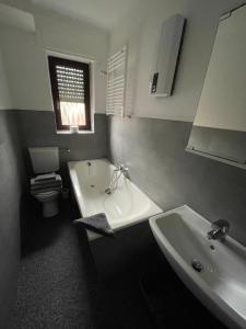 a bathroom with a tub and a sink and a toilet at Apartment im Herzen von Alsdorf in Alsdorf