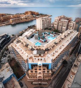 an aerial view of a hotel and the ocean at The St. George’s Park Hotel in St Julian's