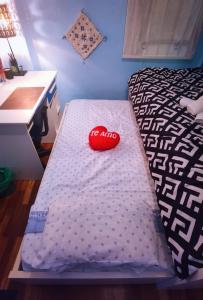 a bed with a red pillow on it in a room at Ganga Room 2 in Bilbao