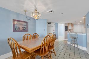 a dining room and kitchen with a table and chairs at Scenic Views from the balcony at Ocean Forest Plaza Condos in Myrtle Beach