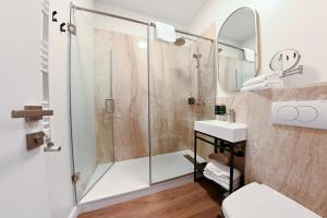 a bathroom with a shower and a sink at Leda Residence in Oradea