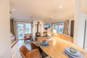 a dining room with a table and chairs and a living room at Romantic getaway, little two bed, two bath barn conversion with amazing views and parking in Ambleside