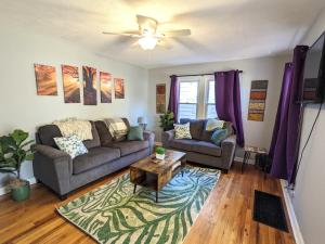 a living room with two couches and a coffee table at Fenced backyard, deck, pet-friendly home in Springfield