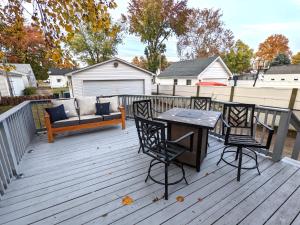a deck with a bench and a table and chairs at Fenced backyard, deck, pet-friendly home in Springfield