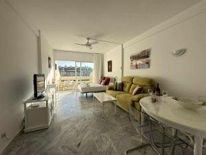 a living room with a couch and a table at Nice Apartament in Puerto Marina in Benalmádena