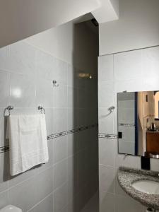 a bathroom with a sink and a mirror at Pousada Maikai Garden in Porto Belo +27 photos