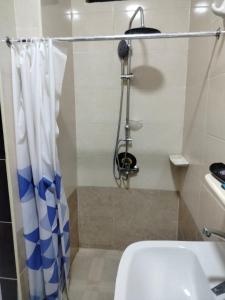 a bathroom with a shower with a toilet and a sink at Hurghada City Apartment 3 in Hurghada
