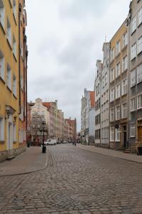 a cobblestone street in a city with buildings at TOTU HOME Chlebnicka Gdańsk Old Town in Gdańsk