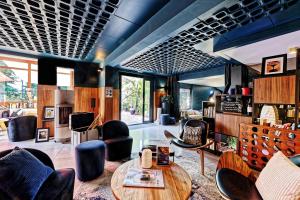 a living room with a table and chairs at Quintessia in Orvault