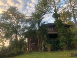 a house with trees in front of it at E-outfitting Valley Resort in Chiang Mai