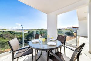a dining room with a table and chairs on a balcony at PROTARAS HEIGHTS in Protaras