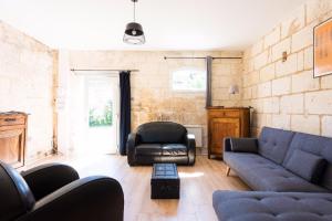 a living room with a couch and a chair at Chateau La Fontaine in Fronsac