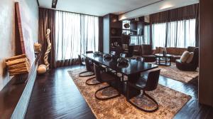 a dining room with a table and a living room at The Canvas Dubai - MGallery Hotel Collection in Dubai +81 photos