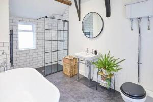 a bathroom with a sink and a toilet and a mirror at Host & Stay - 2 College Square in Stokesley