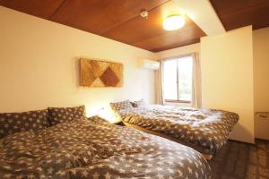 Zimmer mit 2 Betten und einem Sofa in der Unterkunft Open-air bath & Private hot-spring Villa in Hakone in Onsensō