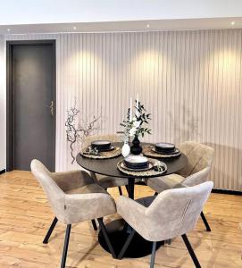 a dining room with a black table and chairs at 1 - 4 Pers. Apartment in Jeßnitz • Mawoi Living 