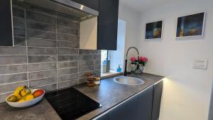 a kitchen with a bowl of fruit on a counter at Fairy Cottage in Lea