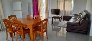 salon ze stołem, krzesłami i kanapą w obiekcie Cozy Appartment w mieście Trianon