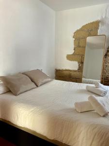 Llit o llits en una habitació de Apartamentos Jerez Siglo XIX