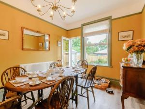 a dining room with a table and chairs and a mirror at 3 bed in Broadstairs 86736 in Broadstairs