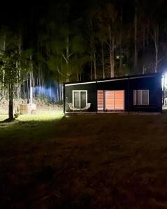 a small house at night in a field at Cabañas Borde Lindo in San José de la Mariquina