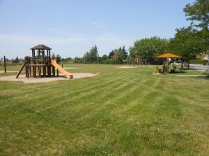 a park with a playground with a slide at Pension im Oderbruch in Manschnow