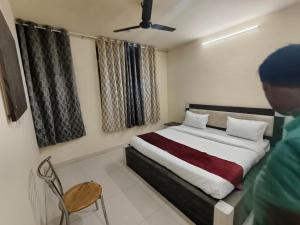 a bedroom with a bed and a chair in it at Hotel Heritage Haveli in Jaipur