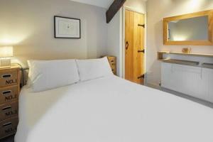 a bedroom with a large white bed and a mirror at Host & Stay - Himmell in Consett