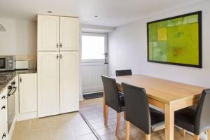 a kitchen with a dining room table and chairs at Host & Stay - Mill in Consett +12 photos