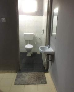 a bathroom with a toilet and a sink at Mtwapa Empire holiday Apartments in Mtwapa