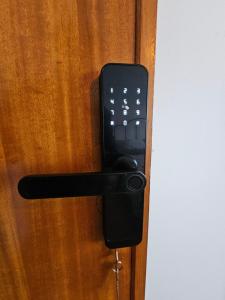 a cell phone is attached to a wooden door at VILLAGE SINTRA gh in Sintra