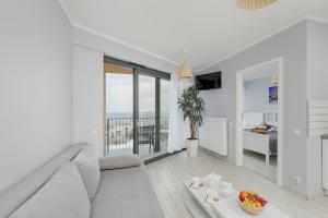 Televízia a/alebo spoločenská miestnosť v ubytovaní Apartamenty Horyzont SeaView by Rent like home