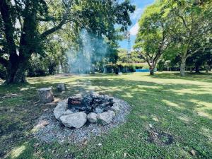 a fire pit in the middle of a park at Cozy Country House in Colonia - Uruguay in Real de San Carlos